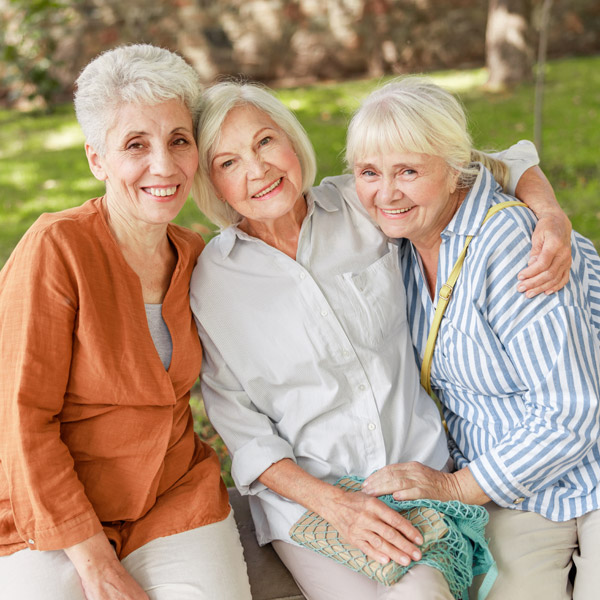 three elderly woman spending time outside together